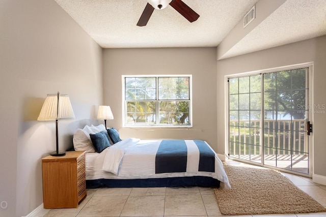 tiled bedroom featuring a textured ceiling, access to outside, and ceiling fan