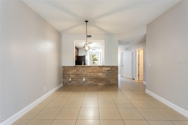 tiled spare room with a textured ceiling