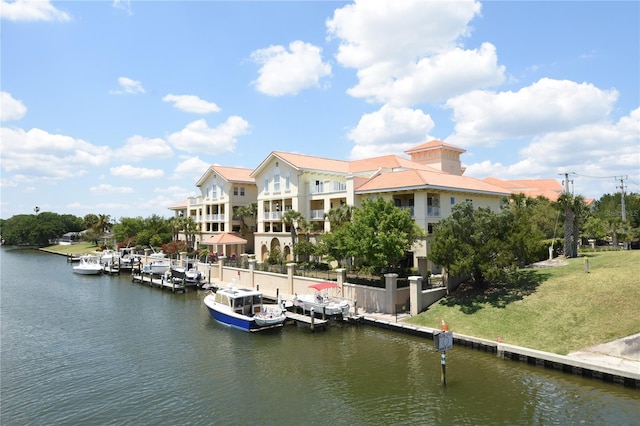 view of dock featuring a water view and a lawn