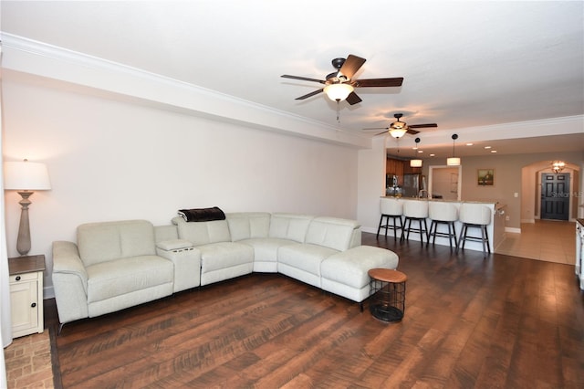 living room with crown molding, ceiling fan, and hardwood / wood-style floors