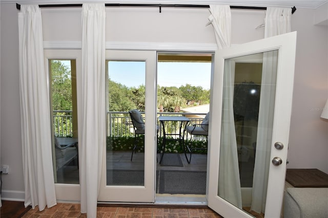 doorway to outside with ornamental molding