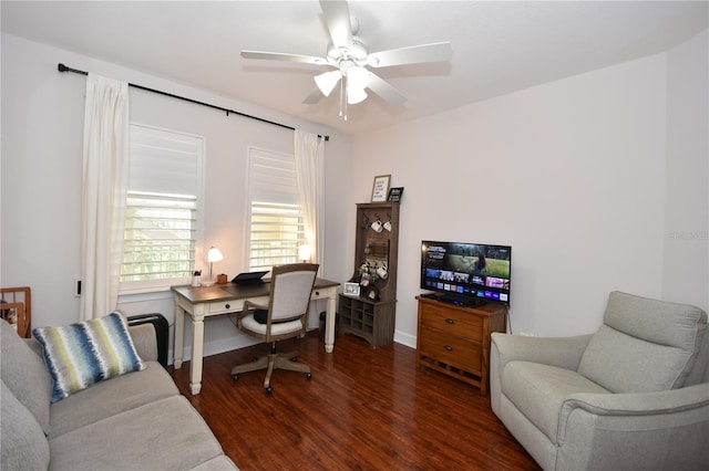 home office with dark wood-type flooring and ceiling fan