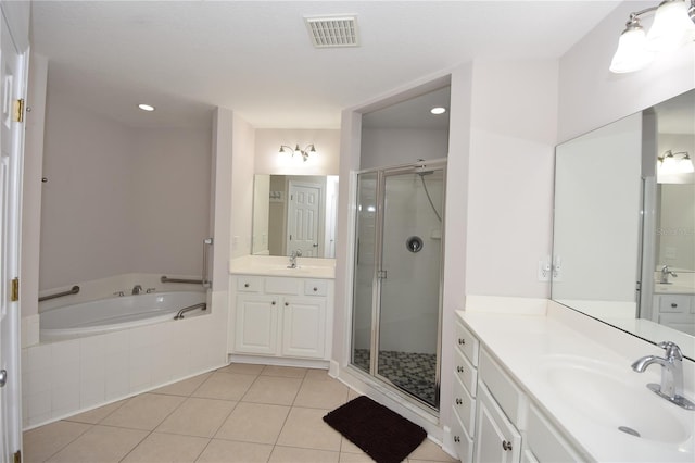 bathroom with plus walk in shower, tile floors, and dual vanity