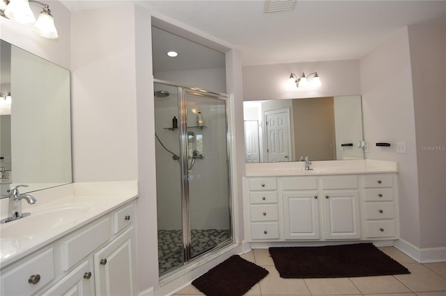 bathroom featuring walk in shower, double vanity, and tile flooring