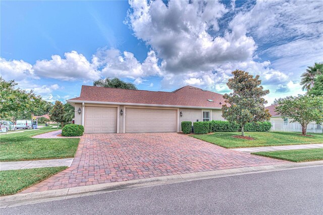 view of front of house featuring a front yard and a garage