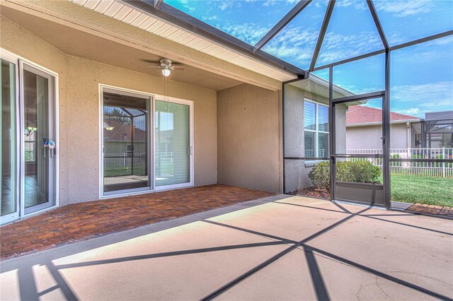 unfurnished sunroom with beamed ceiling and ceiling fan