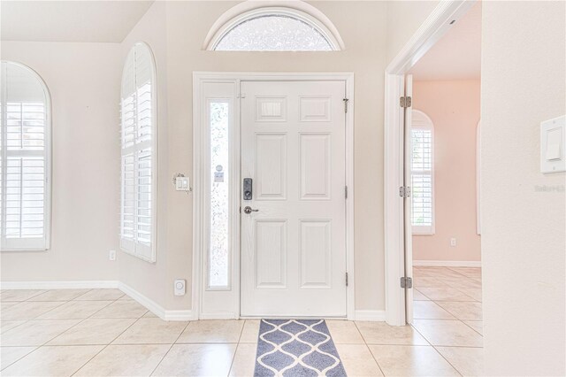 foyer entrance with light tile patterned floors