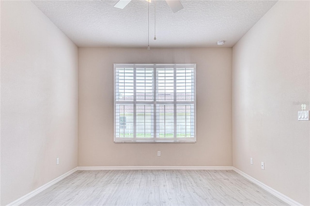 unfurnished room featuring ceiling fan, light hardwood / wood-style flooring, and a textured ceiling