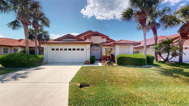 mediterranean / spanish-style house featuring a front lawn and a garage