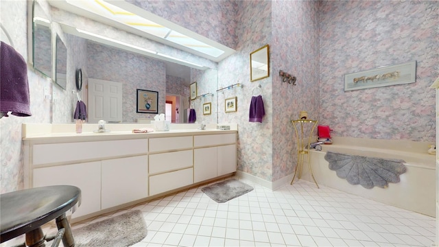 bathroom with tile floors, a bath to relax in, a skylight, and double sink vanity