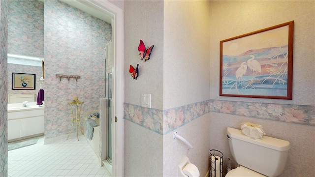 bathroom featuring tile floors, an enclosed shower, vanity, and toilet