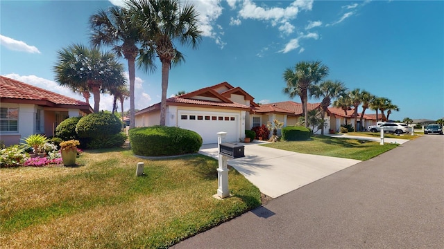 view of front of property with a front lawn and a garage