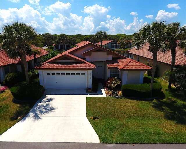 mediterranean / spanish-style home with a front lawn and a garage