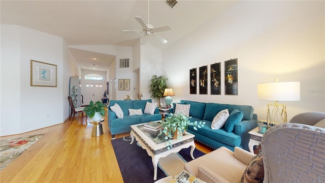 living room with high vaulted ceiling, ceiling fan, and hardwood / wood-style floors