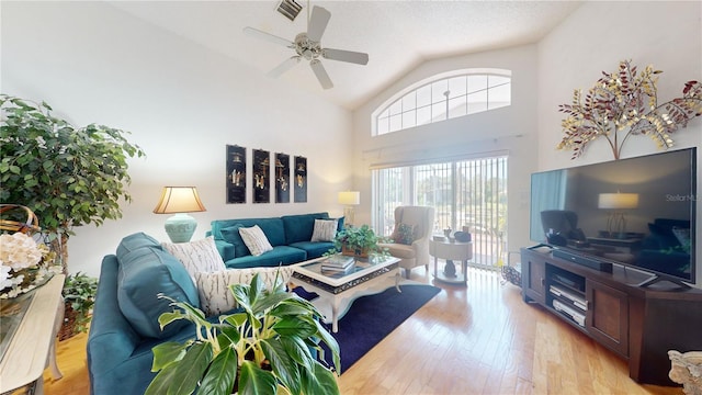 living room featuring high vaulted ceiling, a textured ceiling, wood-type flooring, and ceiling fan