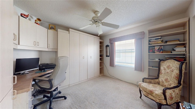 home office featuring ceiling fan, a textured ceiling, and light carpet