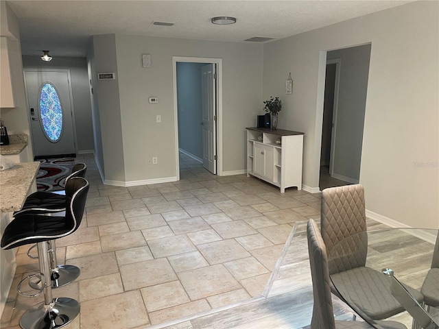 office area featuring a textured ceiling and light tile flooring