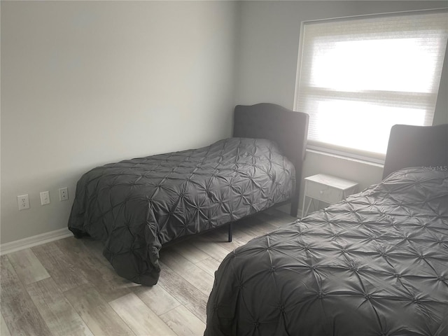 bedroom with hardwood / wood-style flooring