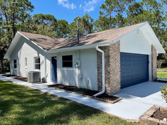 single story home with central AC and a garage