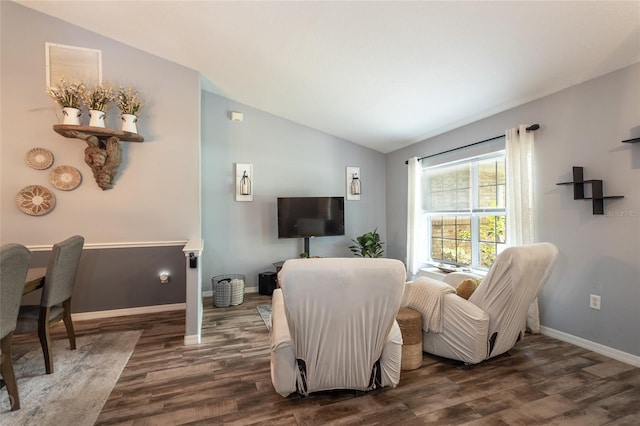 living room with dark hardwood / wood-style flooring and vaulted ceiling