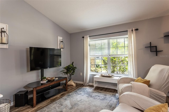 living room with hardwood / wood-style flooring and vaulted ceiling