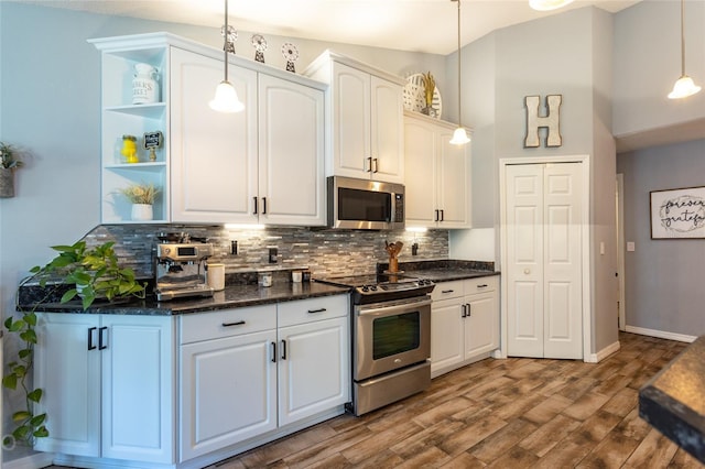 kitchen featuring white cabinetry, appliances with stainless steel finishes, decorative light fixtures, and decorative backsplash