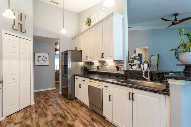 kitchen with white cabinetry, sink, decorative light fixtures, and stainless steel appliances