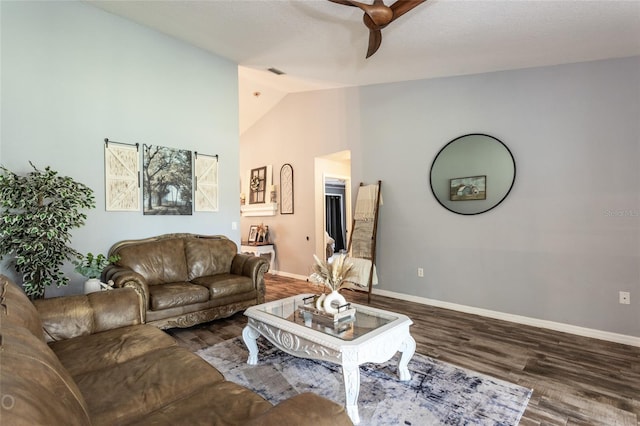 living room featuring dark wood-type flooring and high vaulted ceiling