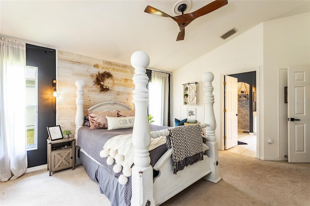 carpeted bedroom with multiple windows, lofted ceiling, ceiling fan, and wood walls