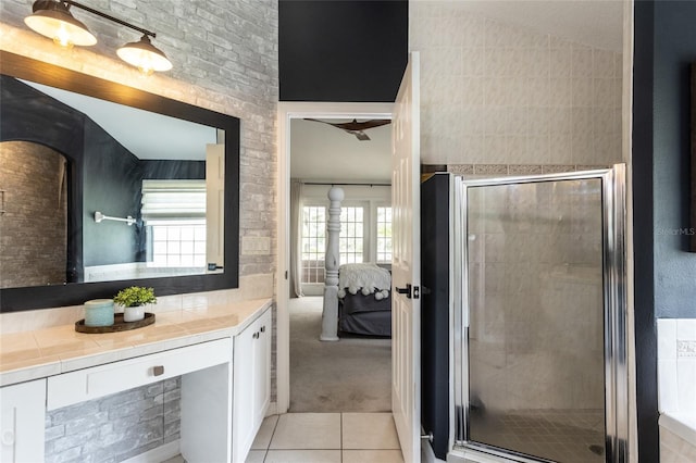 bathroom featuring tile patterned floors, an enclosed shower, and vanity