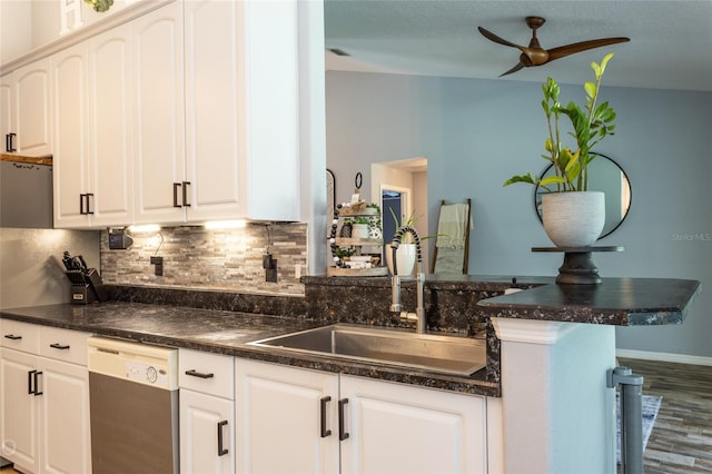 kitchen featuring white cabinetry, dishwasher, sink, decorative backsplash, and kitchen peninsula