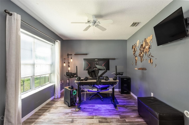 office area featuring hardwood / wood-style flooring, a textured ceiling, and ceiling fan