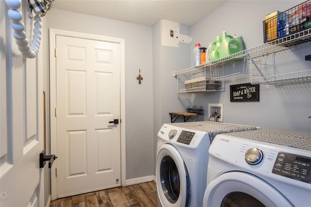 laundry area featuring dark hardwood / wood-style floors, separate washer and dryer, and a textured ceiling