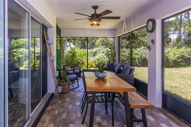 sunroom / solarium featuring ceiling fan