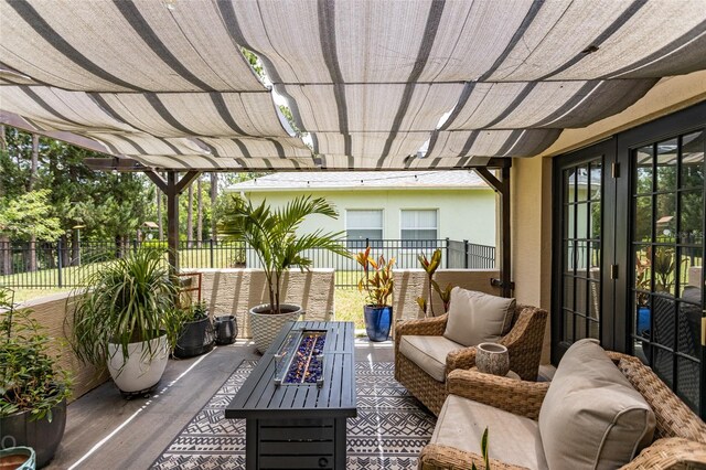 view of patio with a pergola and an outdoor living space with a fire pit