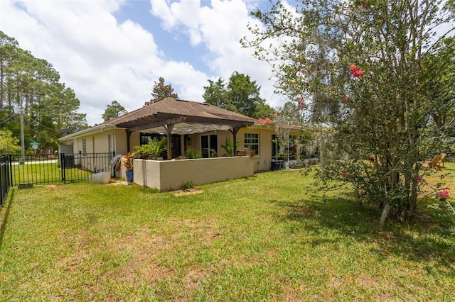 back of property with a pergola and a lawn