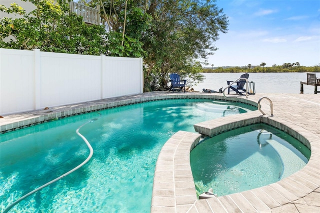 view of swimming pool with an in ground hot tub