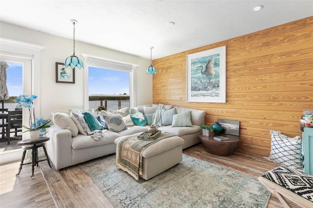 living room with wooden walls and wood-type flooring