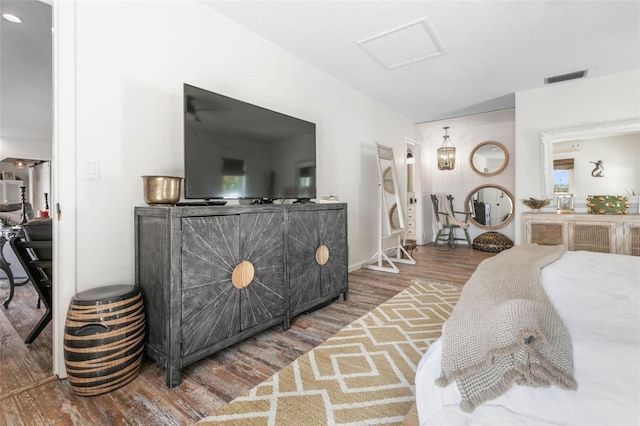 bedroom with dark hardwood / wood-style flooring