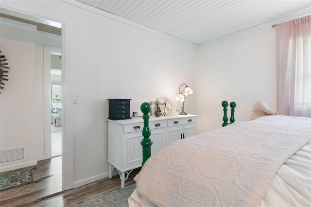 bedroom with dark hardwood / wood-style floors