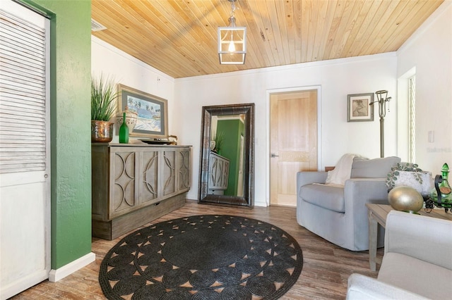 interior space with hardwood / wood-style floors, wooden ceiling, and crown molding