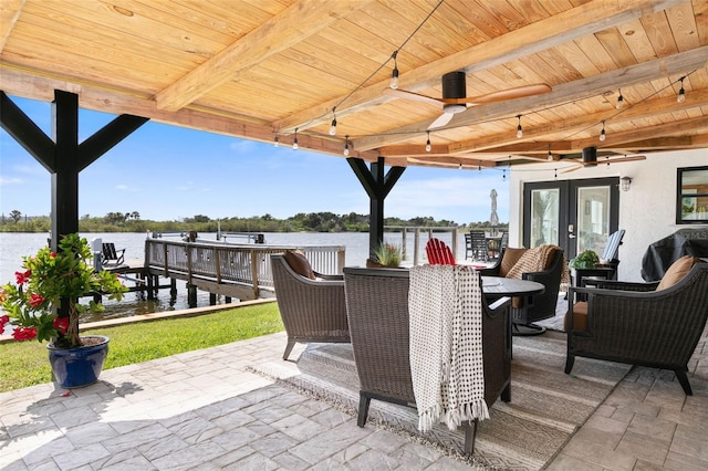 view of terrace featuring a water view and ceiling fan