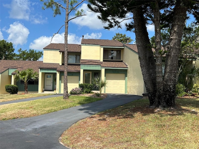 view of front facade featuring a front lawn and a garage