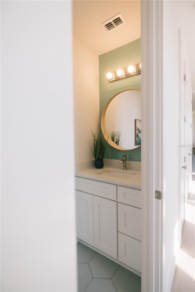 bathroom featuring tile patterned flooring and vanity