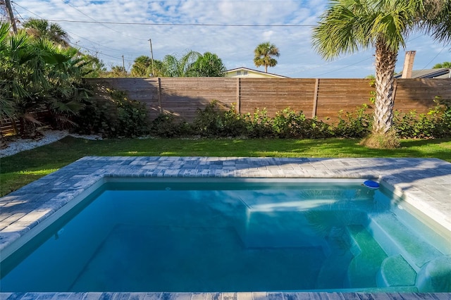 view of pool featuring a yard