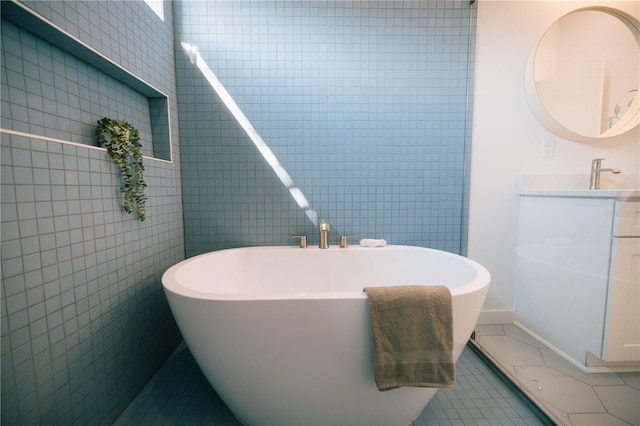 bathroom with tile patterned flooring, tile walls, and a washtub