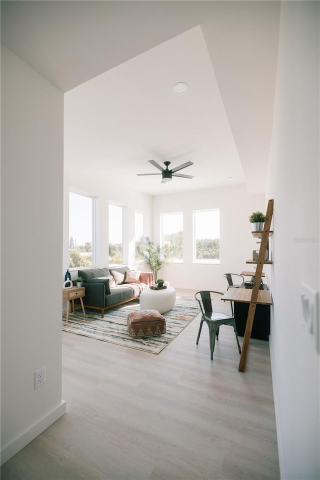 sitting room with light hardwood / wood-style flooring and ceiling fan