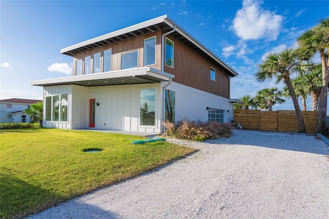 back of house with a lawn