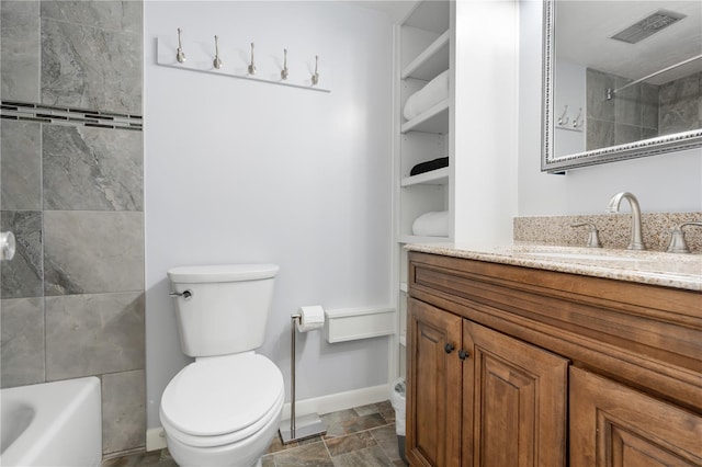 full bathroom featuring vanity, toilet, and tiled shower / bath