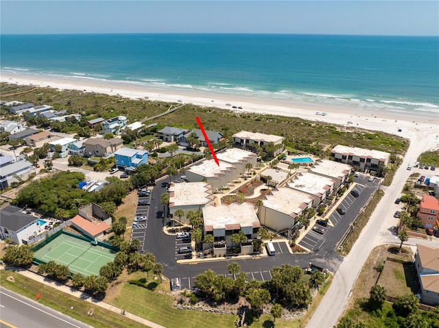 birds eye view of property featuring a beach view and a water view